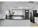 Updated kitchen boasts sleek countertops, white cabinetry, and stainless steel appliances at 3106 S Extension Rd, Mesa, AZ 85210