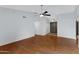 Inviting living room with vaulted ceiling, ceiling fan, and wood flooring at 3106 S Extension Rd, Mesa, AZ 85210