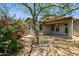 The backyard patio area features a covered space and mature landscaping providing privacy and desert charm at 35314 N 31St Ave, Phoenix, AZ 85086