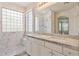 Elegant bathroom featuring a double vanity, glass shower, and marble accents for a spa-like experience at 35314 N 31St Ave, Phoenix, AZ 85086