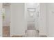 Hallway with views into carpeted bedroom and a wood floored area at 35314 N 31St Ave, Phoenix, AZ 85086
