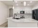 Beautiful kitchen featuring white cabinetry, stainless appliances, and a marble countertop island with a sink at 35314 N 31St Ave, Phoenix, AZ 85086