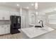 Contemporary kitchen boasts sleek appliances, white cabinets, marble countertops, and stylish pendant lighting at 35314 N 31St Ave, Phoenix, AZ 85086
