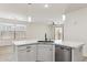 Modern kitchen island with marble countertop and stainless steel dishwasher, complemented by pendant lighting at 35314 N 31St Ave, Phoenix, AZ 85086