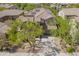This aerial view shows a well-maintained home with solar panels, surrounded by lush greenery at 3818 E Quail Ave, Phoenix, AZ 85050
