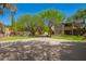 Sprawling backyard featuring desert landscaping, a sports court, and a covered patio at 3818 E Quail Ave, Phoenix, AZ 85050