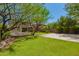 This serene backyard features a basketball court, ample green space, mature trees, and a private pool area at 3818 E Quail Ave, Phoenix, AZ 85050