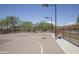 Outdoor basketball court with well-maintained surface and clear blue sky above at 3818 E Quail Ave, Phoenix, AZ 85050