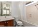 Bathroom featuring a bathtub, shower with curtain, and wood vanity at 3818 E Quail Ave, Phoenix, AZ 85050