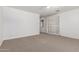 Spacious bedroom with neutral carpet, a ceiling fan, and sliding closet doors at 3818 E Quail Ave, Phoenix, AZ 85050
