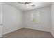 A bedroom with neutral carpet, ceiling fan and window with shutters at 3818 E Quail Ave, Phoenix, AZ 85050