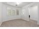 Neutral carpeted room with shutters and a nook that could be used as an office at 3818 E Quail Ave, Phoenix, AZ 85050
