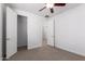 A bedroom with neutral carpet, ceiling fan and two doors at 3818 E Quail Ave, Phoenix, AZ 85050