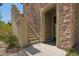 Inviting front entrance with stone accents, stairs, and a beautifully designed doorway at 3818 E Quail Ave, Phoenix, AZ 85050