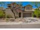 Charming two-story home featuring a stone facade, manicured landscaping, and a welcoming entry at 3818 E Quail Ave, Phoenix, AZ 85050