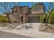 Charming two-story home featuring a stone facade, manicured landscaping, and a welcoming entry at 3818 E Quail Ave, Phoenix, AZ 85050