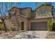 Charming two-story house with stone accents, a two-car garage, and a well-maintained front yard at 3818 E Quail Ave, Phoenix, AZ 85050