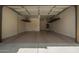 Spacious three car garage featuring epoxy floor, overhead storage, and a door to the interior at 3818 E Quail Ave, Phoenix, AZ 85050