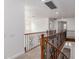 This hallway boasts a brown wood and iron railing and bright walls at 3818 E Quail Ave, Phoenix, AZ 85050