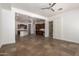 Spacious living room with tile floors, ceiling fan and views into the modern kitchen at 3818 E Quail Ave, Phoenix, AZ 85050