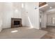Spacious living room boasting high ceilings, a stone fireplace, and abundant natural light at 3818 E Quail Ave, Phoenix, AZ 85050