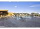 Large outdoor swimming pool surrounded by lounge chairs and cabanas, with a clear blue sky above at 3818 E Quail Ave, Phoenix, AZ 85050