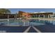 This swimming pool with white umbrellas features a unique building design at 3818 E Quail Ave, Phoenix, AZ 85050