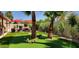 Beautiful backyard with putting green, mature landscaping, and red umbrellas at 4617 E Emile Zola Ave, Phoenix, AZ 85032