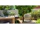 Backyard with a hot tub, stainless steel BBQ grill, and mature landscaping at 4617 E Emile Zola Ave, Phoenix, AZ 85032