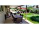 Backyard featuring covered patio with dining, a pool, putting green, and lush landscaping at 4617 E Emile Zola Ave, Phoenix, AZ 85032