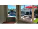 Relaxing backyard pool view through a window, complete with waterfall feature and lounge chairs at 4617 E Emile Zola Ave, Phoenix, AZ 85032