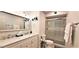 Bright bathroom with double sinks, modern fixtures, and a glass-enclosed shower with tile surround at 4617 E Emile Zola Ave, Phoenix, AZ 85032