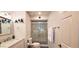 Well-lit bathroom featuring a glass-enclosed shower with tile surround and single sink vanity at 4617 E Emile Zola Ave, Phoenix, AZ 85032