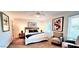 Cozy bedroom features a ceiling fan, neutral walls, and comfortable seating area near a window at 4617 E Emile Zola Ave, Phoenix, AZ 85032