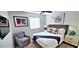 Bedroom features a TV, ceiling fan, artwork, and large window at 4617 E Emile Zola Ave, Phoenix, AZ 85032