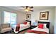 Bright bedroom showcases two twin beds, ceiling fan, neutral paint, and window at 4617 E Emile Zola Ave, Phoenix, AZ 85032