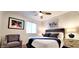 Cozy bedroom features a comfortable bed, accent chair, ceiling fan, and stylish decor at 4617 E Emile Zola Ave, Phoenix, AZ 85032
