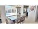 Bright dining room with chandelier, overlooking the pool through large windows at 4617 E Emile Zola Ave, Phoenix, AZ 85032