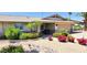Home with a two-car garage, stone accents, desert landscaping, and flowering bushes at 4617 E Emile Zola Ave, Phoenix, AZ 85032