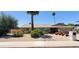 Single-story home showcasing desert landscaping, a two-car garage, and a well-maintained lawn at 4617 E Emile Zola Ave, Phoenix, AZ 85032