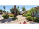 Beautiful desert landscape, mature palm trees, and shrubs surrounding the exterior of a well-kept home at 4617 E Emile Zola Ave, Phoenix, AZ 85032