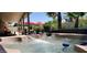 Inviting hot tub with cascading waterfall feature and a view of the manicured backyard at 4617 E Emile Zola Ave, Phoenix, AZ 85032