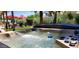 Close-up of a bubbling hot tub with a landscaped backyard in the background at 4617 E Emile Zola Ave, Phoenix, AZ 85032