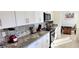 Modern kitchen with white cabinets, stainless steel appliances, and granite countertops for a sleek look at 4617 E Emile Zola Ave, Phoenix, AZ 85032