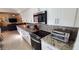 Modern kitchen with white cabinets, granite countertops, and stainless steel appliances, perfect for cooking at 4617 E Emile Zola Ave, Phoenix, AZ 85032