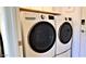 Modern laundry area showcases a stacked washer and dryer unit at 4617 E Emile Zola Ave, Phoenix, AZ 85032