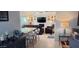 Open floor plan showcasing a bar with seating and a comfortable living room with a fireplace and TV at 4617 E Emile Zola Ave, Phoenix, AZ 85032