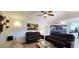 Comfortable living room with leather sofas, a ceiling fan, and ample space for relaxation and entertainment at 4617 E Emile Zola Ave, Phoenix, AZ 85032