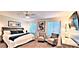Stylish bedroom with a large bed, seating area, and natural light at 4617 E Emile Zola Ave, Phoenix, AZ 85032
