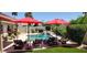 Backyard pool featuring a waterfall, lounge chairs, and lush landscaping, creating a serene outdoor space at 4617 E Emile Zola Ave, Phoenix, AZ 85032